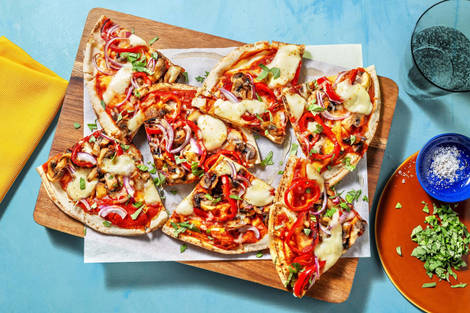 Pizza sur pain plat garnie de champignons et mozzarella