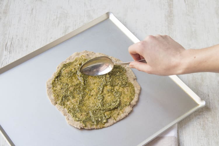 Spread the pizza base with the pesto