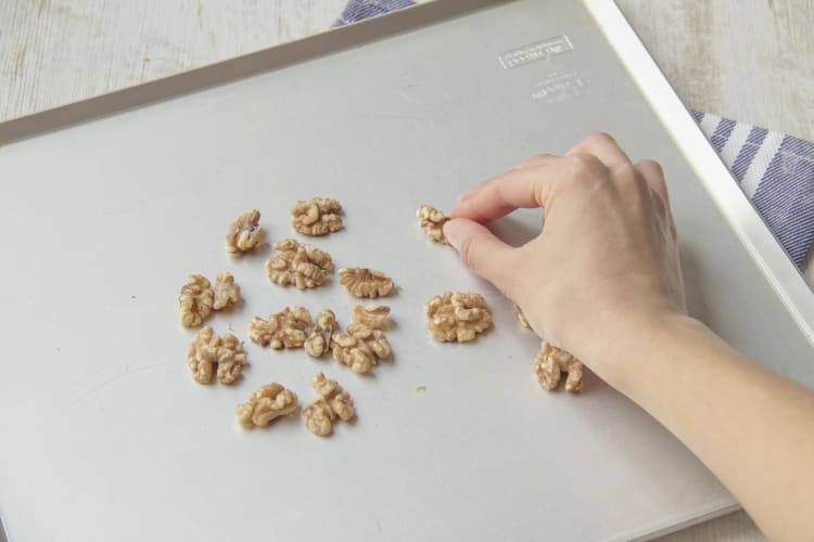 Spread walnuts on baking tray