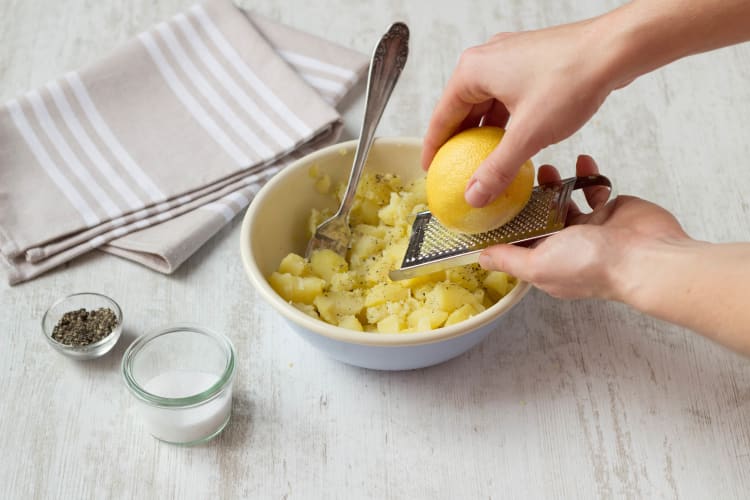 Grate lemon zest over potatoes