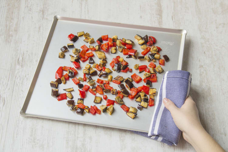 Place aubergine and peppers on a baking tray