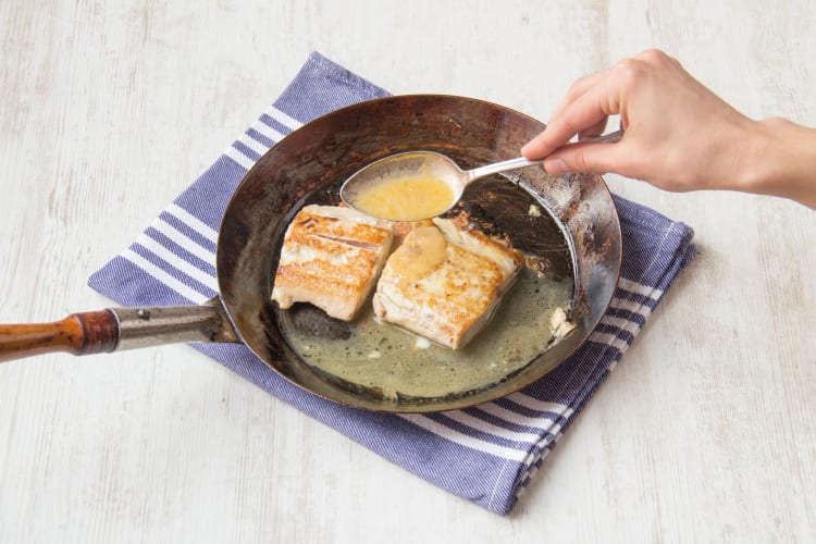 Spoon butter-lemon sauce over salmon