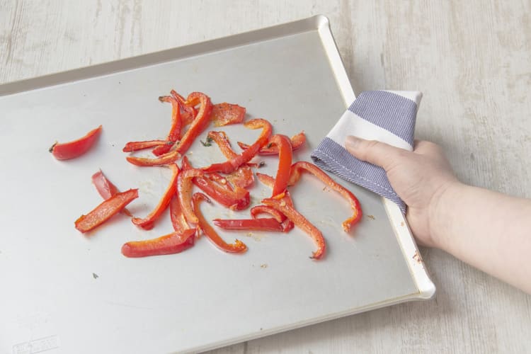 Toss bell pepper on backing sheet