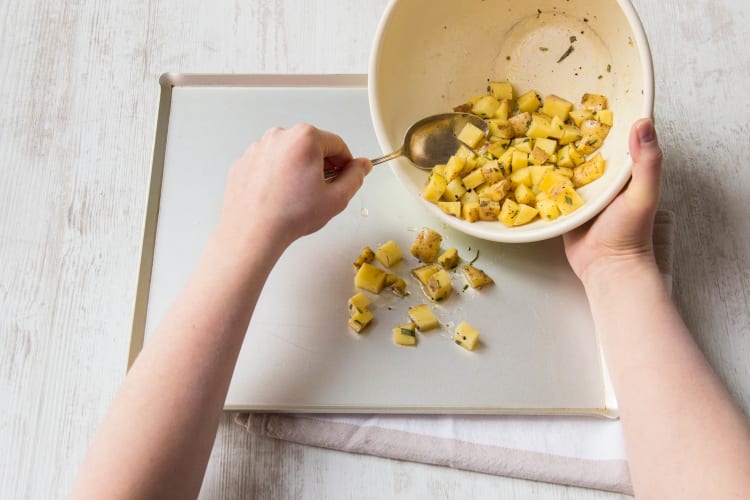 Toss the potatoes with half the rosemary.