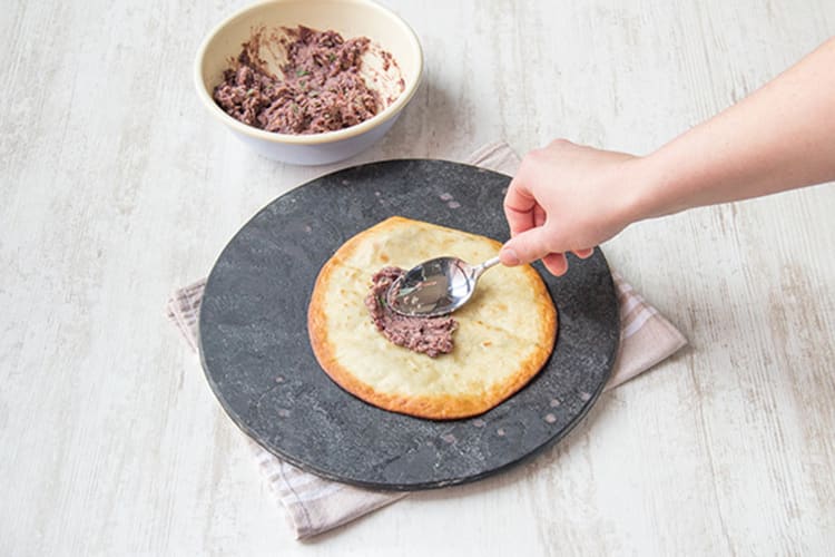 Dollop some beans over the tostada