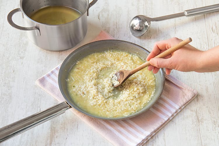 Add stock slowly to Arborio rice