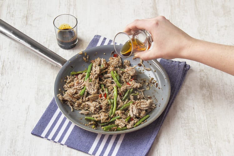 Add kecap manis and fish sauce to pork