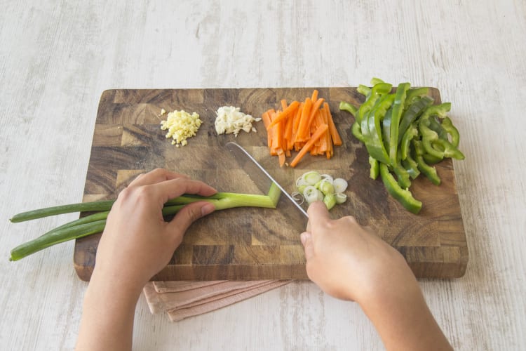 Slice spring onion into discs