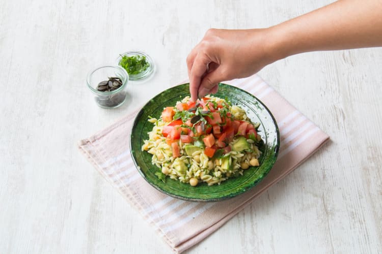 Top the orzo with the marinated tomatoes