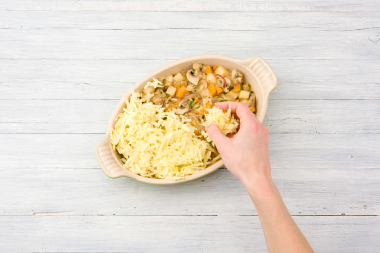 Top the pie with grated carrot and parsnip