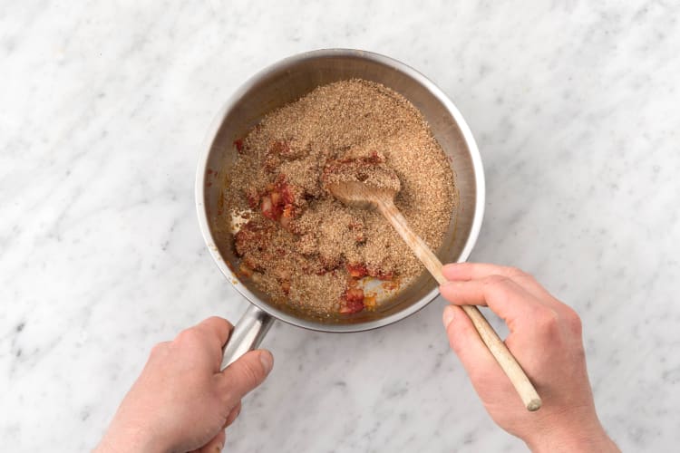 Add the spices and tomato puree