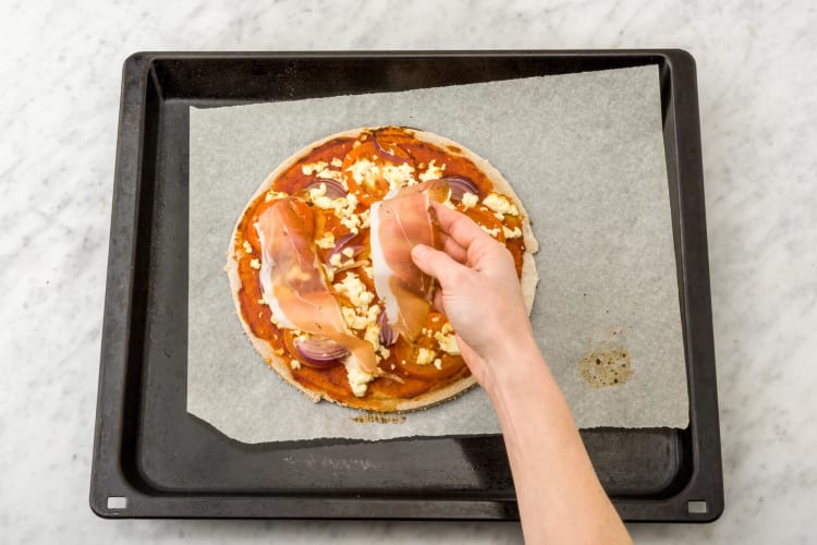 Top the pizzas