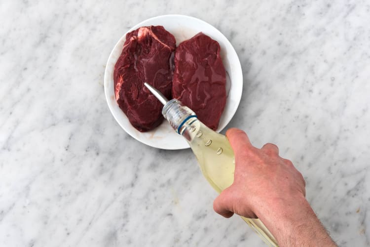 Drizzle olive oil over the steak