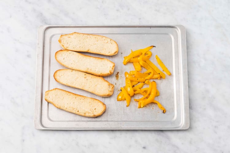 Broil peppers and toast rolls