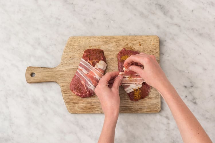 Cook potatoes and prep steaks