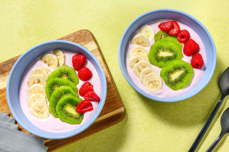 Roze smoothiebowl met verse frambozen en banaan