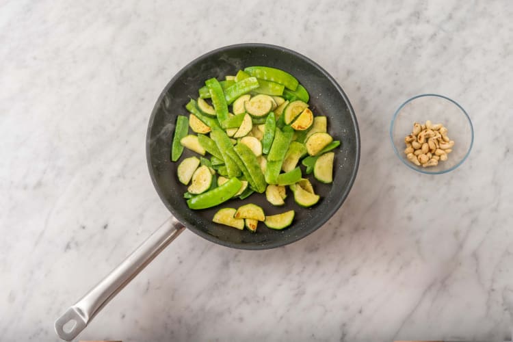 Toast cashews and cook veggies