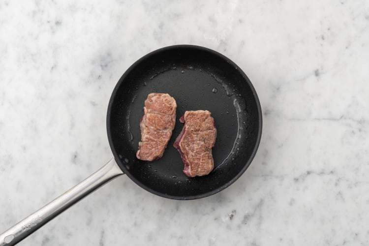 Cook steaks and snap peas