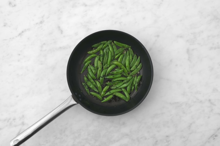 Make herbed butter and cook snap peas