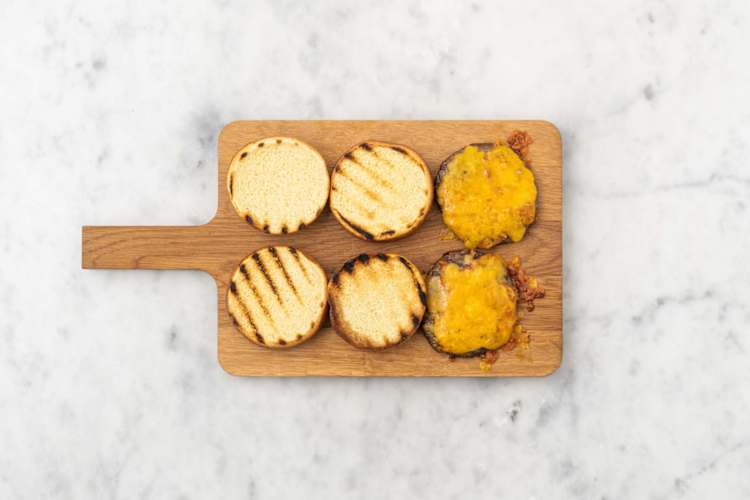 Toast buns and melt cheese