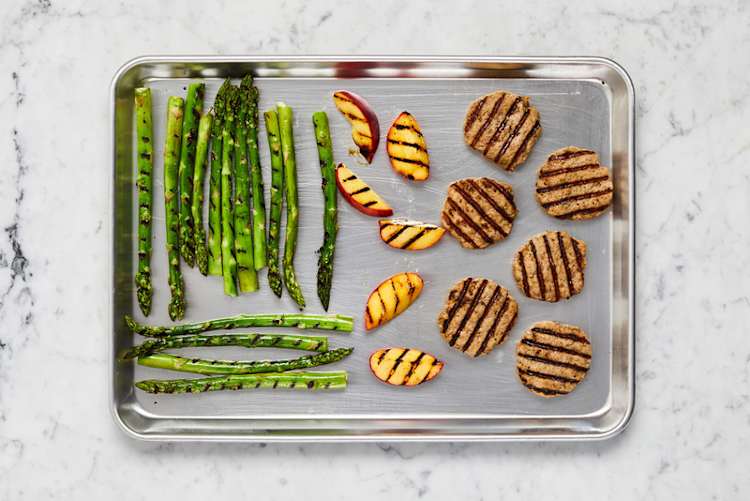 Grill patties, fruit and asparagus