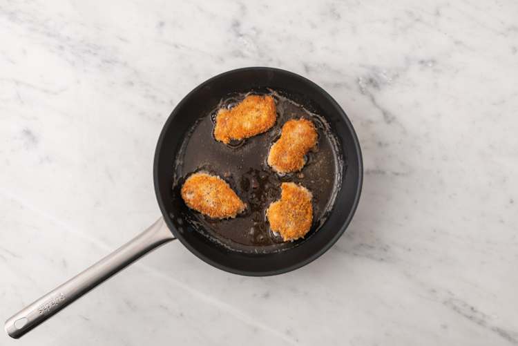Cook the plant-based crumbed chicken 