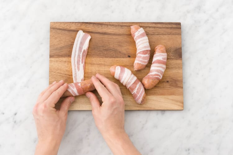 Wrap sausages in bacon.