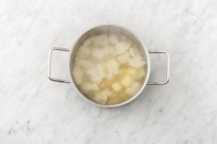 Boil potatoes and cauliflower