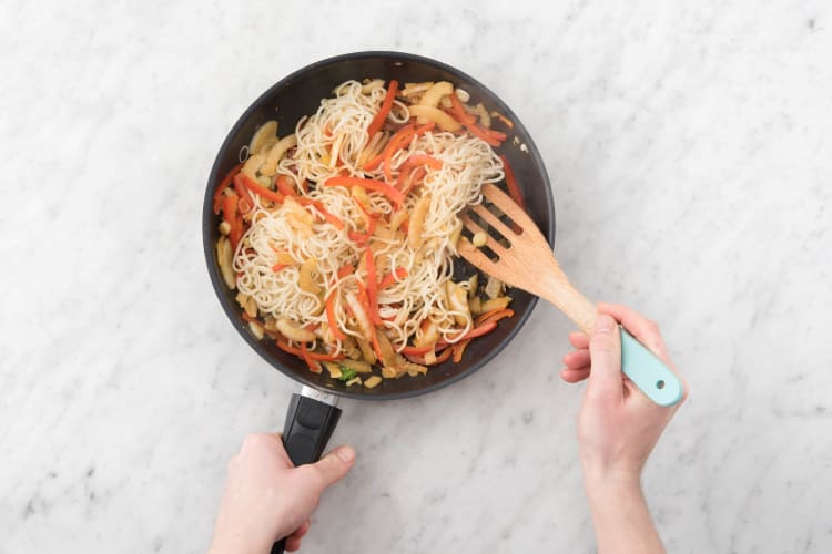 Voeg de noedels toe aan de wok of hapjespan met deksel